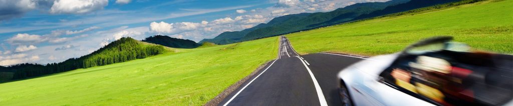 Photo of convertible driving through countryside