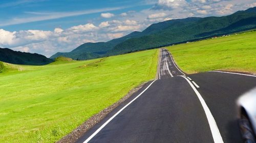 Photo of convertible driving through countryside