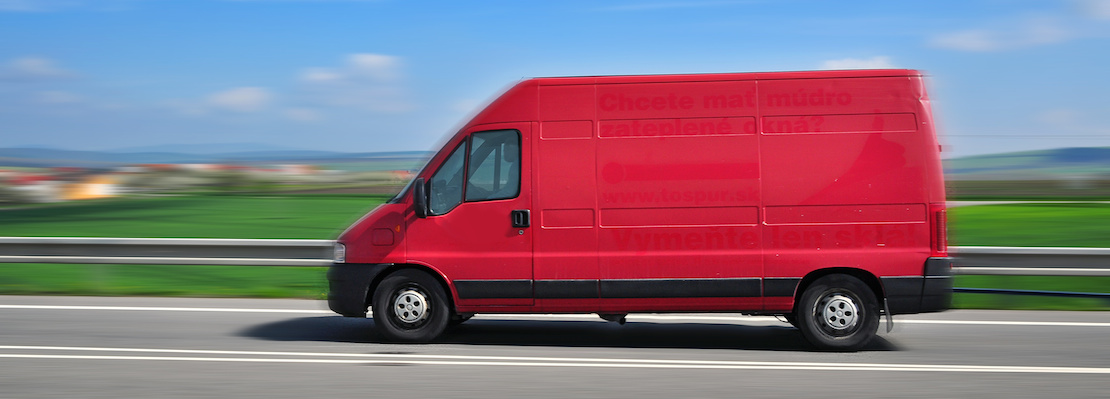 Image showing blurry (suggesting speed) van riding by road